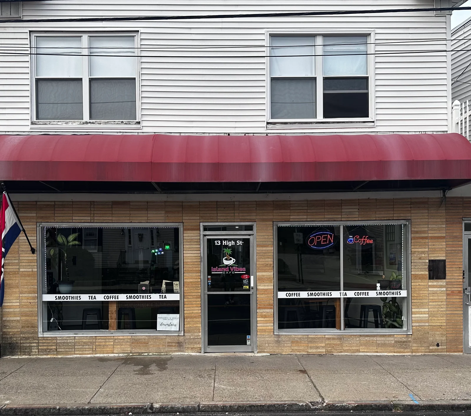 Island Vibes Cafe storefront in Hampton with window lettering and a branded entrance door.